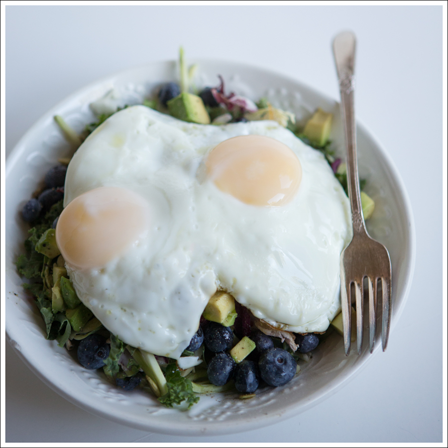 Blog Paleo Kale Broccoli Brussel Sprout Salad with Blueberries Avocado topped with a Fried Egg-1